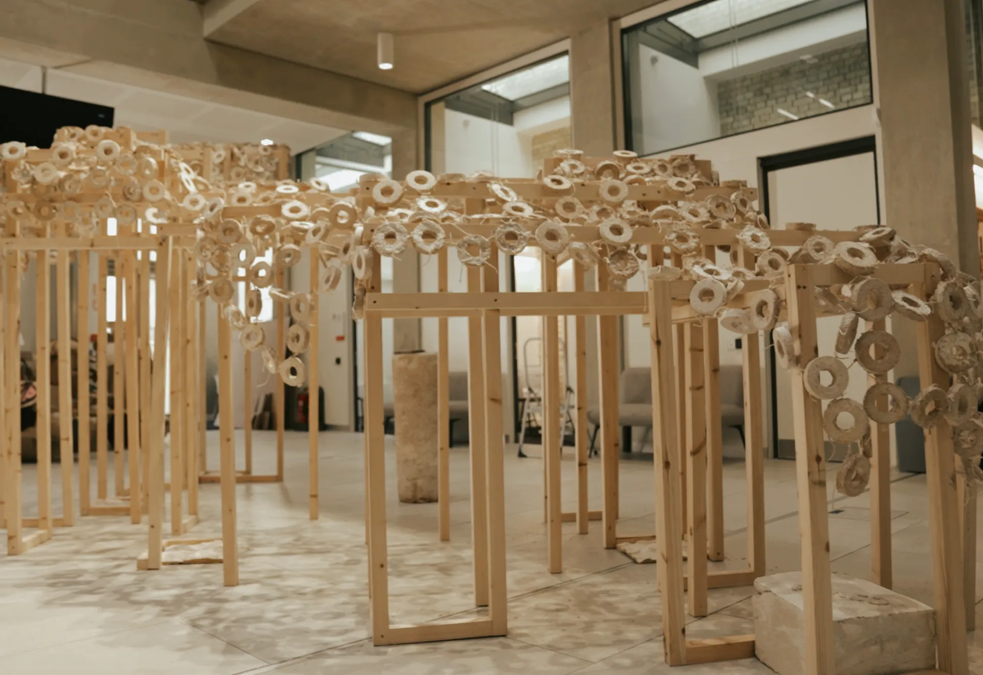 A mycelium pavilion installation made from repeated sculptural forms and timber frames
